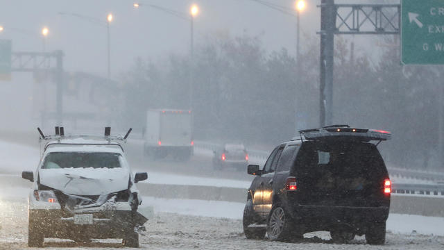 Two vehicles sit on the fast lane of Interstate 80 after an accident during a snowstorm Dec. 17, 2016, in Lodi, N.J. 