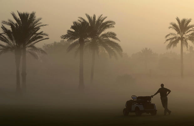 A marshal looks through the early morning fog which delayed the 1st round of the Dubai Ladies Masters golf tournament in Dubai, United Arab Emirates, Dec. 7, 2016. 