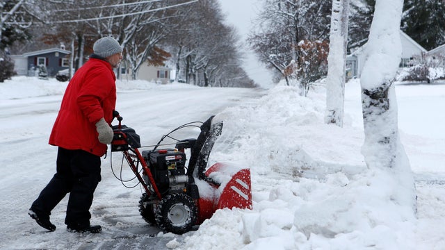 Tom Sargent pushes his snowblower up his driveway in Bangor, Maine, Dec. 30, 2016. 