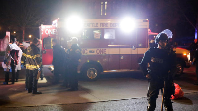 A Seattle Police officer is pictured near an ambulance where one person was shot at the University of Washington, where protesters arrived outside a speaking engagement by Breitbart News editor Milo Yiannopoulosin in Seattle, Washington, Jan. 20, 2017. 