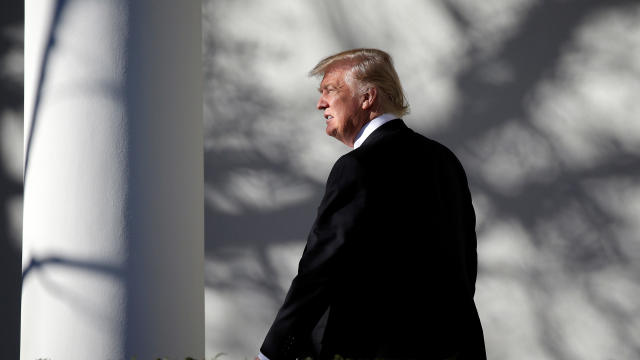 President Trump walks through the Colonnade to the Oval Office after returning to the White House in Washington Jan. 26, 2017. 