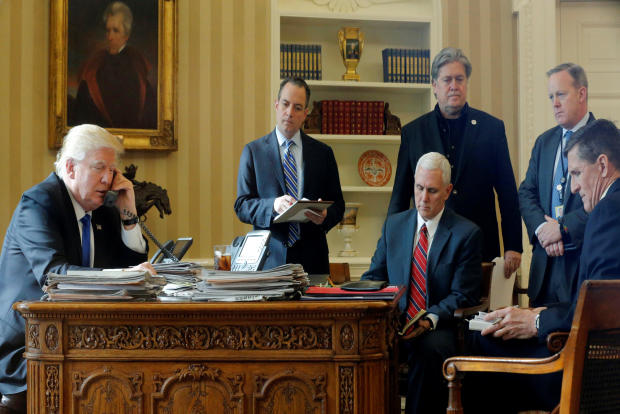 President Donald Trump, joined by, from left to right, chief of staff Reince Priebus, Vice President Mike Pence, senior adviser Steve Bannon, Communications Director Sean Spicer and National Security Adviser Michael Flynn, speaks by phone with Russia’s President Vladimir Putin in the Oval Office at the White House in Washington Jan. 28, 2017. 