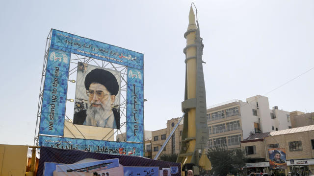 A Ghadr-F missile is displayed next to a portrait of Iran’s Supreme Leader Ayatollah Ali Khamenei at a war exhibition to commemorate the 1980-88 Iran-Iraq war at Baharestan square, south of Tehran, on Sept. 26, 2016. 