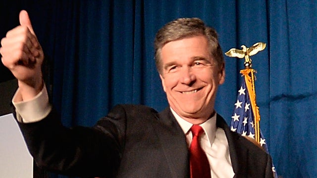 North Carolina Democratic presumptive Gov.-elect Roy Cooper waves to a crowd at the North Carolina Democratic Watch Party as he walks on stage with his family on Nov. 9, 2016, in Raleigh, North Carolina. 