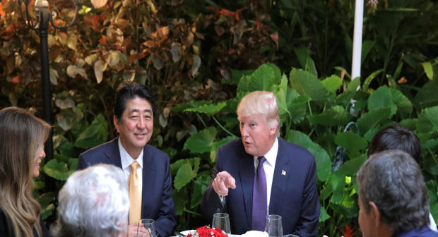 Japanese Prime Minister Shinzo Abe and Akie Abe, right, partially obscured, attend dinner with President Trump, his wife Melania and Robert Kraft, second left, owner of the New England Patriots, at Mar-a-Lago Club in Palm Beach, Florida, Feb. 10, 2017. 