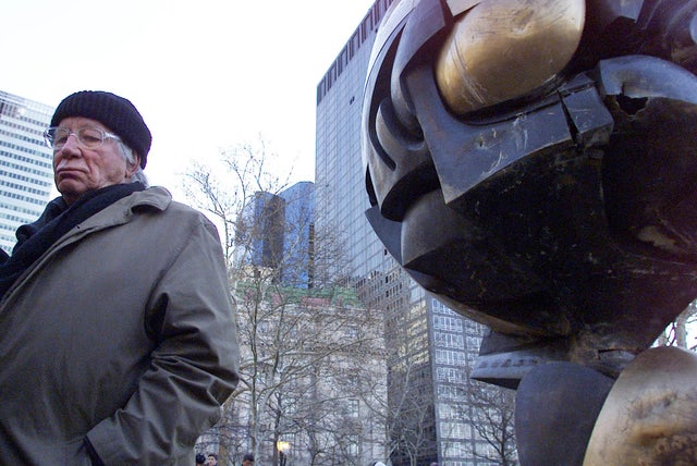 German artist Fritz Koenig stands next to his bronze sculpture &ldquo;The Sphere&rdquo; after a dedication ceremony in New York on March 11, 2002. 