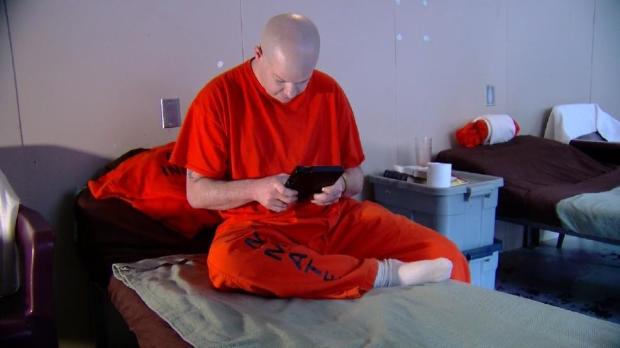 Dennis Nopper, an inmate in the Albany County Jail in New York, uses a tablet provided to inmates under a new program. 