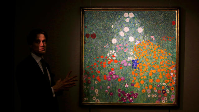 An expert from Sotheby’s introduces “Bauerngarten” by Austrian artist Gustav Klimt during a preview in Hong Kong Feb. 14, 2017, before it is auctioned at an impressionist and modern art sale in London in March. 