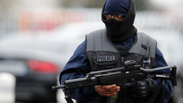 A French policeman secures the area at Paris’ Orly airport on March 18, 2017, following the shooting of a man by French security forces. 