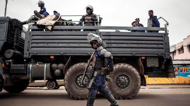 A policeman walks in front of a police truck as the Congolese capital Kinshasa was gripped by a strike called “Villes mortes” (Dead cities) on Oct. 19, 2016, in a protest over plans by the president to stay in power beyond the end of his term in December. 