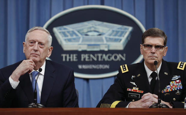 Defense Secretary Jim Mattis, left, and Gen. Joseph Votel listen to questions during a news conference at the Pentagon April 11, 2017. 