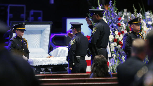 Law enforcement pay respects during a viewing before the funeral service for Dallas Police Senior Cpl. Lorne Ahrens held at Prestonwood Baptist Church on July 13, 2016, in Plano, Texas. 