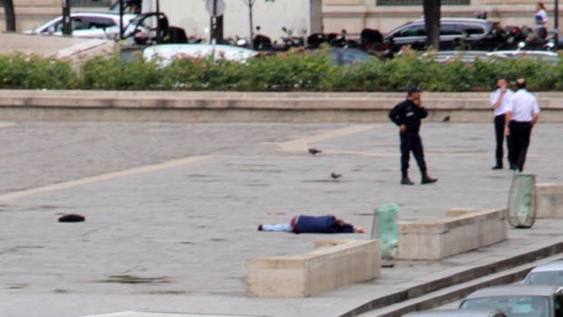 A man lies on the ground outside Notre Dame Cathedral after attacking police officers in Paris on June 6, 2017, in this picture provided to CBS News. 