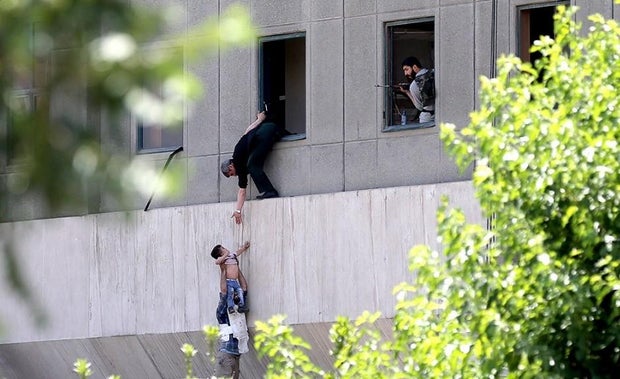 child-man-rescue-iran-tehran-attack.jpg