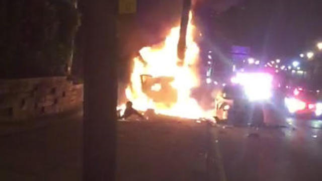 A man who had just rolled out of one of two burning cars is seen in this screen capture from cellphone video with flames coming from what looks like his upper torso after a wild police pursuit in Jersey City, N.J., late on June 4, 2017. 