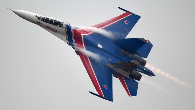 A member of the Russian air force's Knights aerobatic team performs in a SU-27 jet during a test flight ahead of an airshow in Zhuhai, China, on Nov. 10, 2014. 