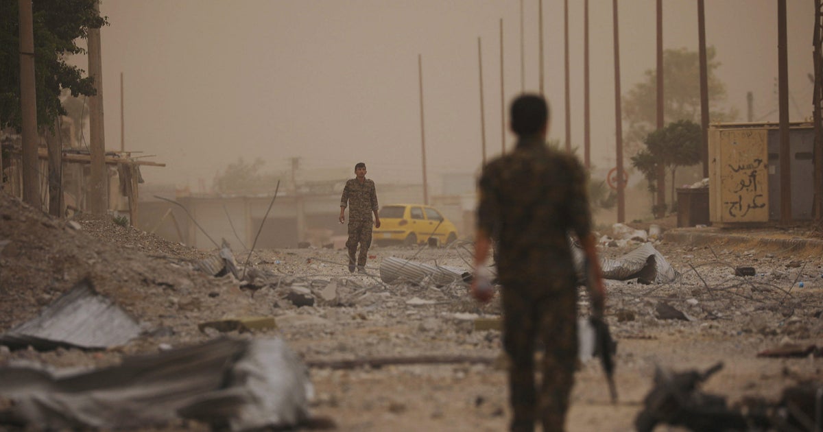Syrian forces backed by U.S. seize last road into Raqqa - CBS News