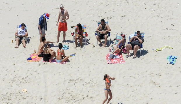 In this July 2, 2017, photo, New Jersey Gov. Chris Christie, right, uses the beach with his family and friends at the governor's summer house at Island Beach State Park in New Jersey. 