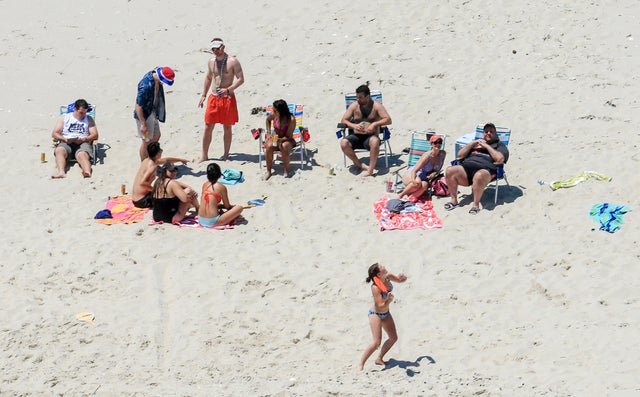 In this July 2, 2017, photo, New Jersey Gov. Chris Christie, right, uses the beach with his family and friends at the governor's summer house at Island Beach State Park in New Jersey. 