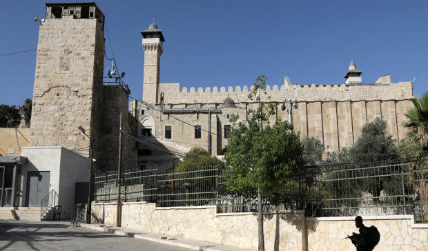 An Israeli soldier walks past Ibrahimi Mosque, which Jews call the Tomb of the Patriarchs, in the West Bank city of Hebron July 7, 2017. 