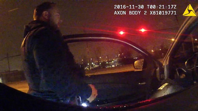 A Baltimore police officer is seen in body camera footage that appears to show officers placing drugs in a car during a traffic stop on Nov. 30, 2016. 