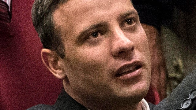 Olympic athlete Oscar Pistorius holds the hand of a relative after sentencing on July 6, 2016, at the High Court in Pretoria, South Africa. 