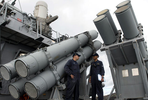 U.S. Navy personnel stand in front of a guided missile launcher during a bilateral maritime exercise between the Philippine navy and U.S. Navy aboard the USS John S. McCain in the South China Sea near waters claimed by Beijing on June 28, 2014. 