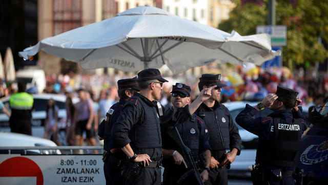 Police officers stand at a road block at the beginning of fiestas in Bilbao, after a van ran down pedestrians in Barcelona's Las Ramblas on Thursday 