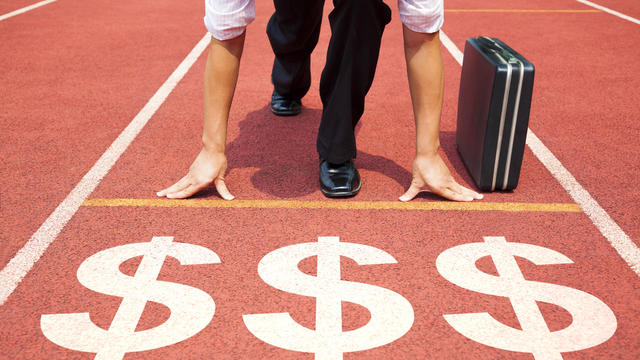 businessman getting ready for race on the track 