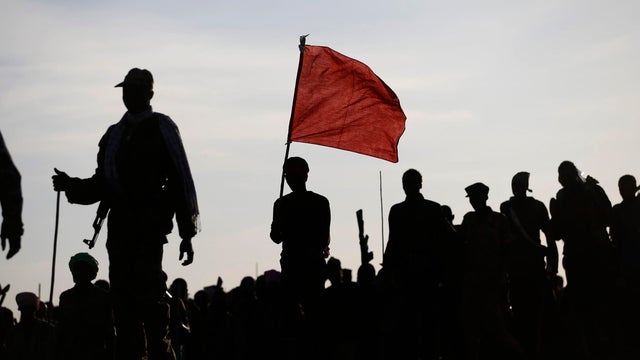 Rebel fighters walk in a rebel controlled territory in Upper Nile State 