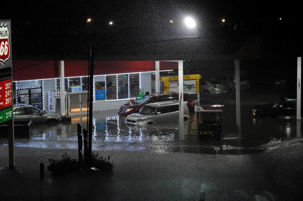 Cars sit abandoned at a flooded gas station after Hurricane Harvey made landfall on the Texas Gulf coast and brought heavy rain to the region 
