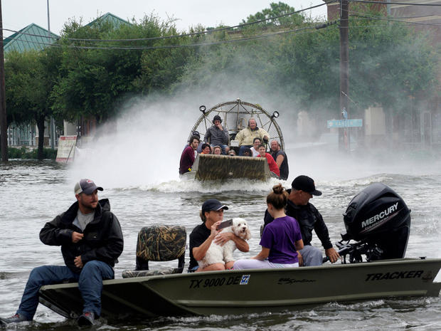 People are rescued from flood waters from Hurricane Harvey on an air boat in Dickinson 
