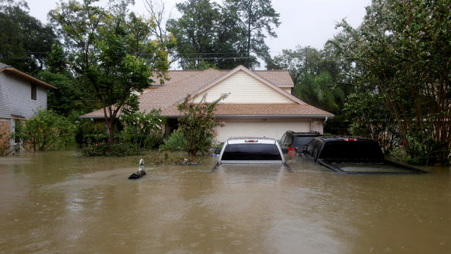 FILE PHOTO:    Houses and cars are seen partially submerged by flood waters from tropical storm Harvey in east Houston 