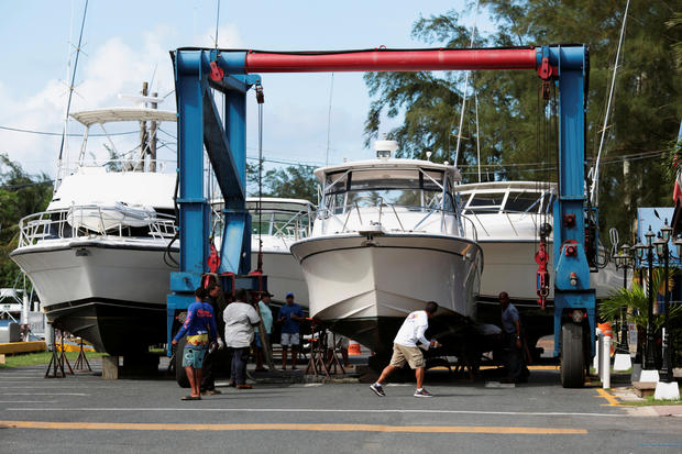Workers put boats on dry docks in preparation, as Hurricane Irma, barreling towards the Caribbean and the southern United States, was upgraded to a Category 4 storm, in San Juan 