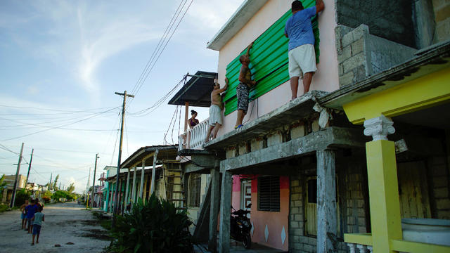 People protect the windows of a house prior to the arrival of the Hurricane Irma in Caibarien 