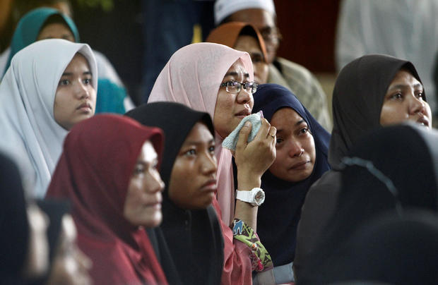 Family members wait for news of their loved ones outside religious school Darul Quran Ittifaqiyah after a fire broke out in Kuala Lumpur 