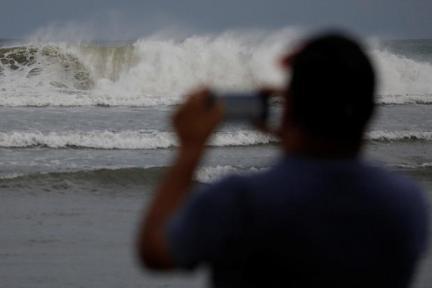 A man photographs the waves before the arrival of the Hurricane Maria in Guayama 