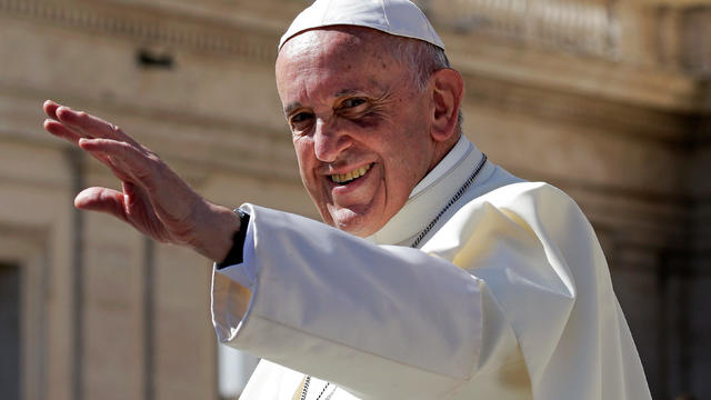 Pope Francis waves at the end of the Wednesday general audience in Saint Peter's Square at the Vatican 