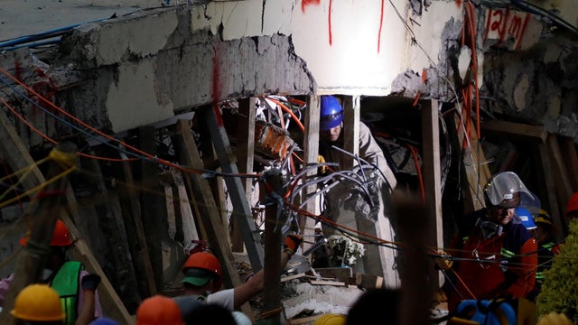 Rescue workers search through the rubble for students at Enrique Rebsamen school after an earthquake in Mexico City 