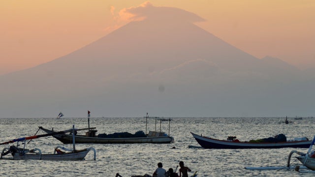 Mount Agung, an active volcano located on the resort island of Bali that has been placed on alert level 3 following recent seismic activity, is seen from Mataram on nearby Lombok island 