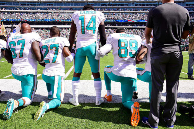 New York Jets lock arms, four Miami Dolphins kneel during national