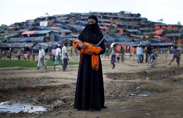 Rohingya refugee Minara Begum, 18, holds her sick nine-day-old daughter 