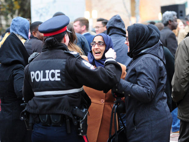 Muslim women speak to a police woman during a rally, organised by the Alberta Muslim Public Affairs Council in solidarity with the Edmonton Police Service, following an attack in Edmonton, Canada 
