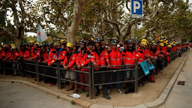 Firemen stand as they take part in a protest two days after the banned independence referendum in Barcelona 