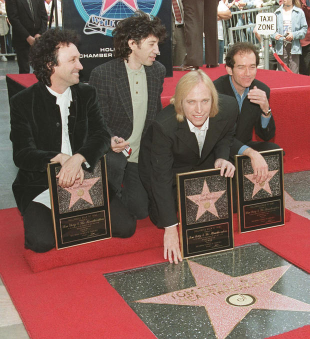 Musician Tom Petty (3rd-L) touches the star he and 