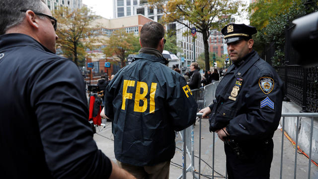 FBI agents enter through a police barricade along Chambers street a day after a man driving a rented pickup truck mowed down pedestrians and cyclists on a bike path alongside the Hudson River in New York City 