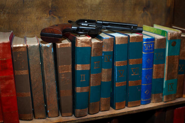 shelf with books gun 
