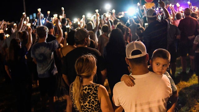 Local residents embrace during a candlelight vigil for victims of a mass shooting in a church in Sutherland Springs, Texas 