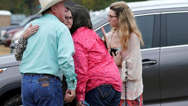 People hug after the First Baptist Church of Sutherland Springs worship service, the first service since a gunman opened fire inside the church a week earlier in Sutherland Springs 
