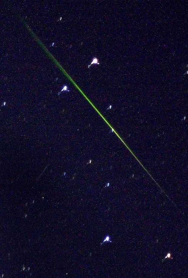 The green streak of a meteor seen in the southern 